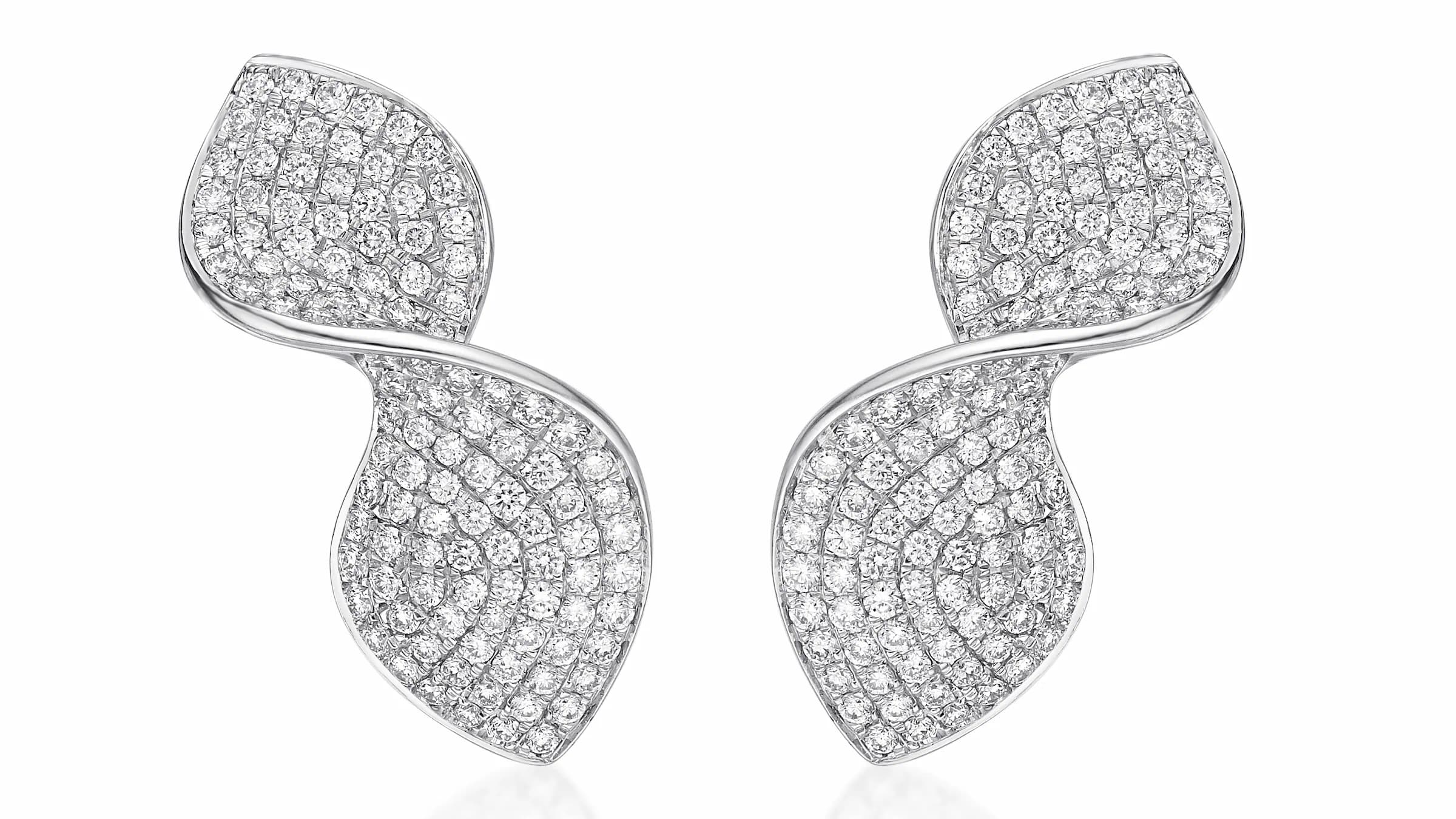 Infinity diamond earrings on neutral background