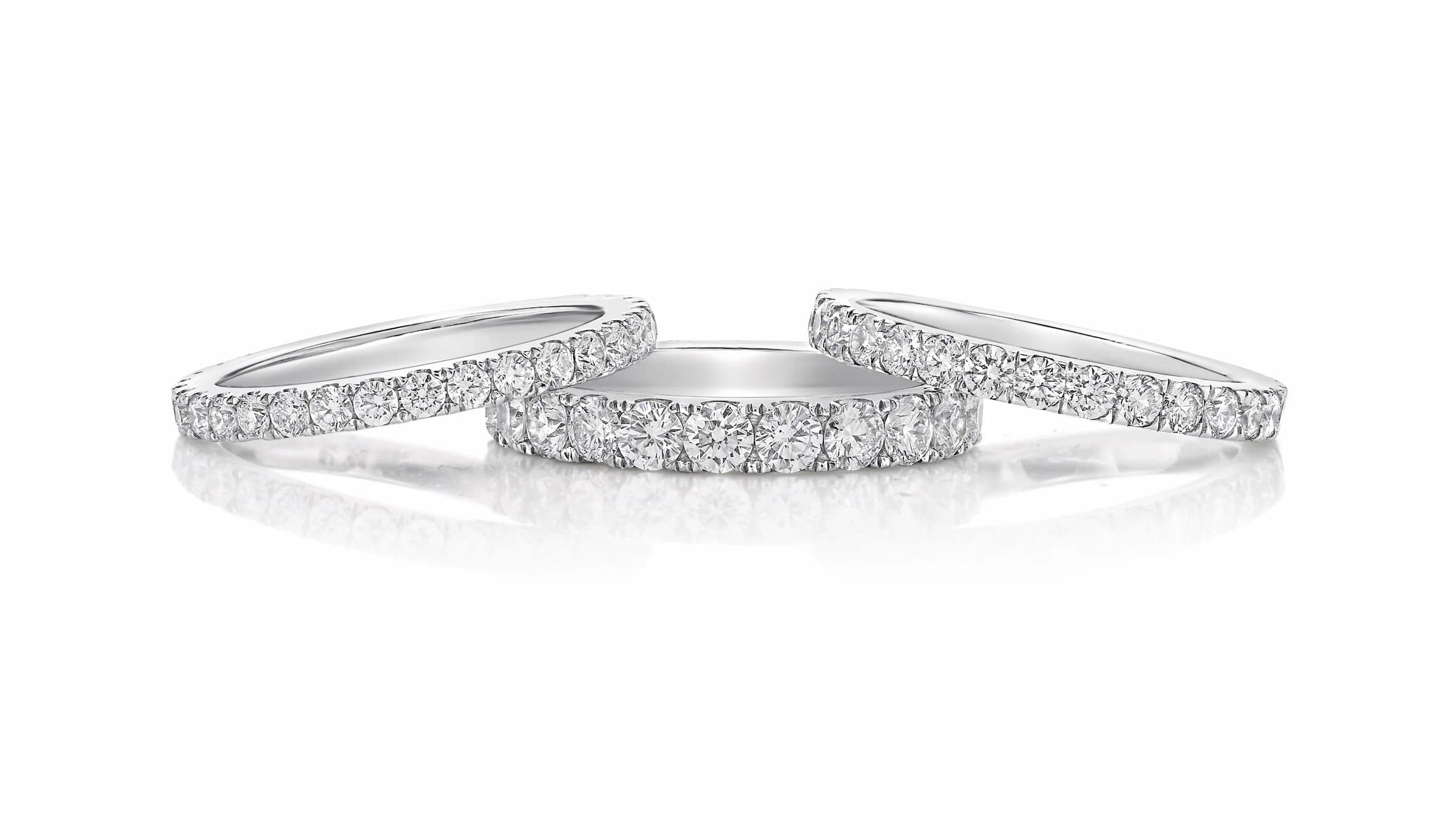 Wall-set eternity ring stack on neutral background